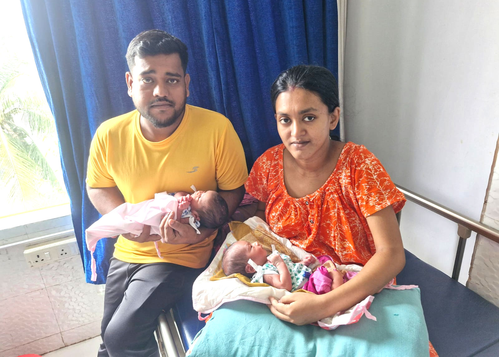 Consent-approved family care moment with newborn twins