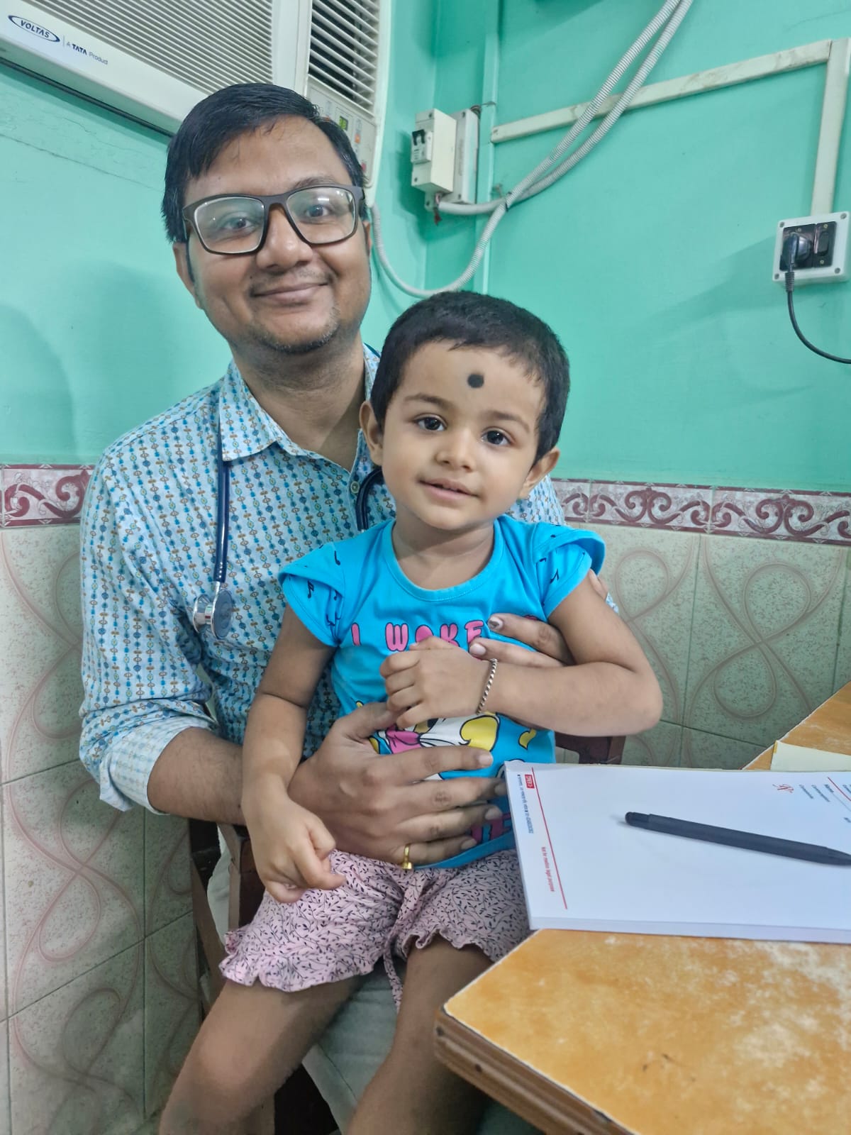 Dr. Surajit Hazra with a child patient at the clinic