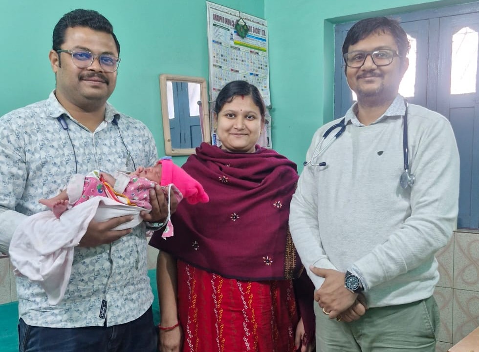 Dr. Surajit Hazra with a family and newborn at the clinic
