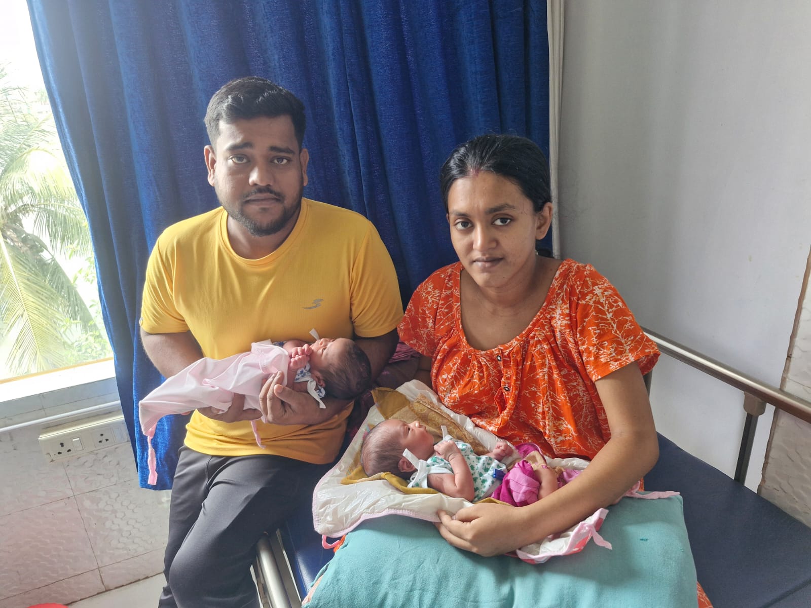 Parents with newborn twins at the clinic