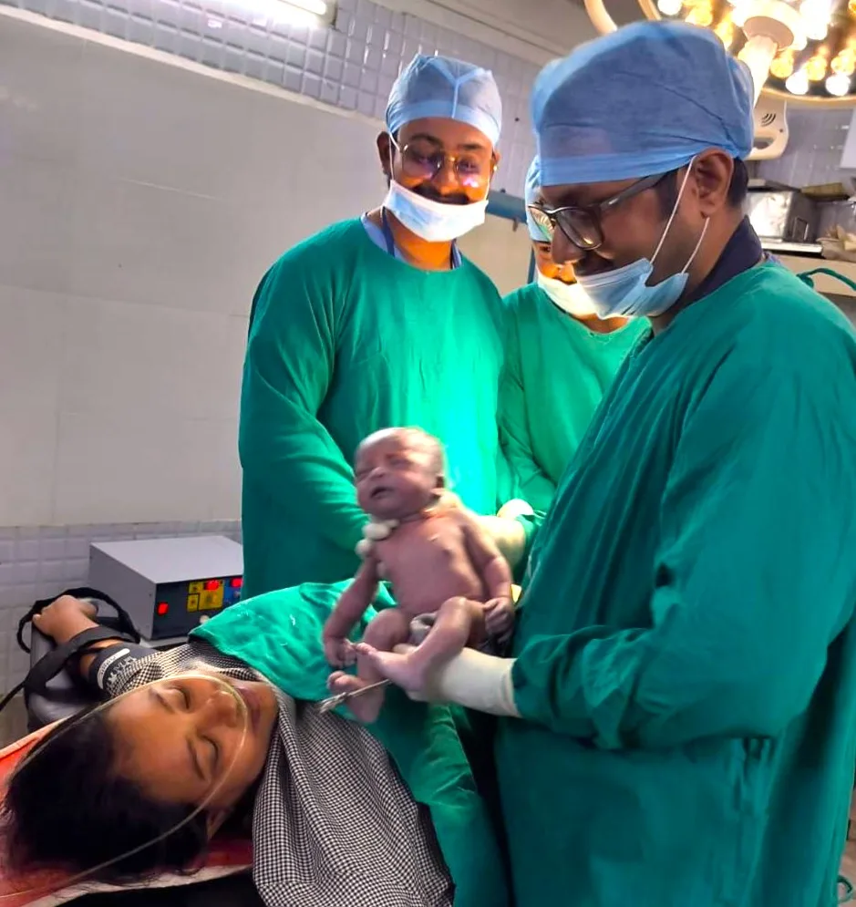 Clinical team providing immediate newborn care in an operating theatre