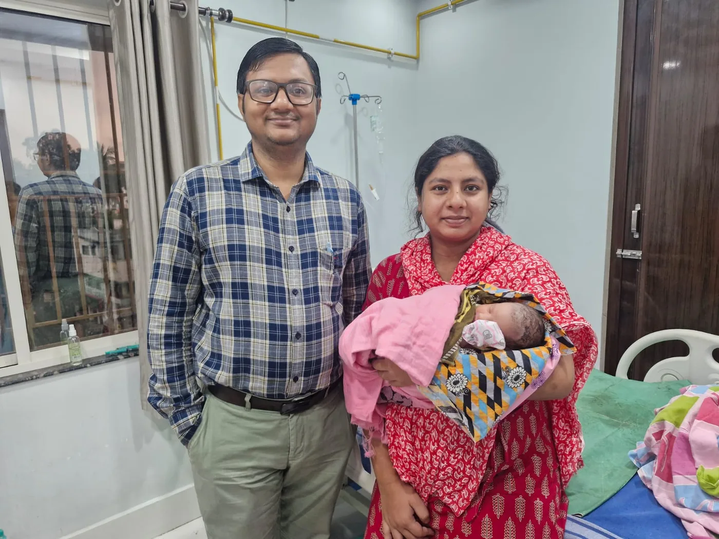 Clinician with a mother and newborn during hospital care